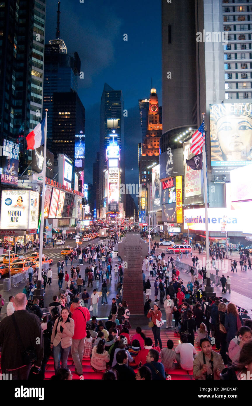 Bustling Times Square illuminated by corporate billboards and congested ...