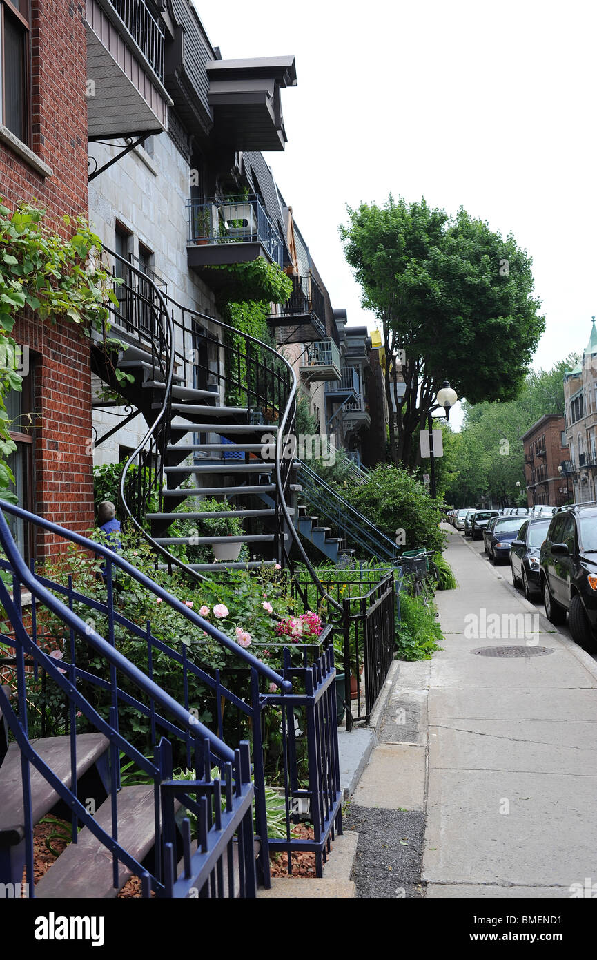 Houses with outside spiral staircases along a road in residential part of Montreal. Stock Photo