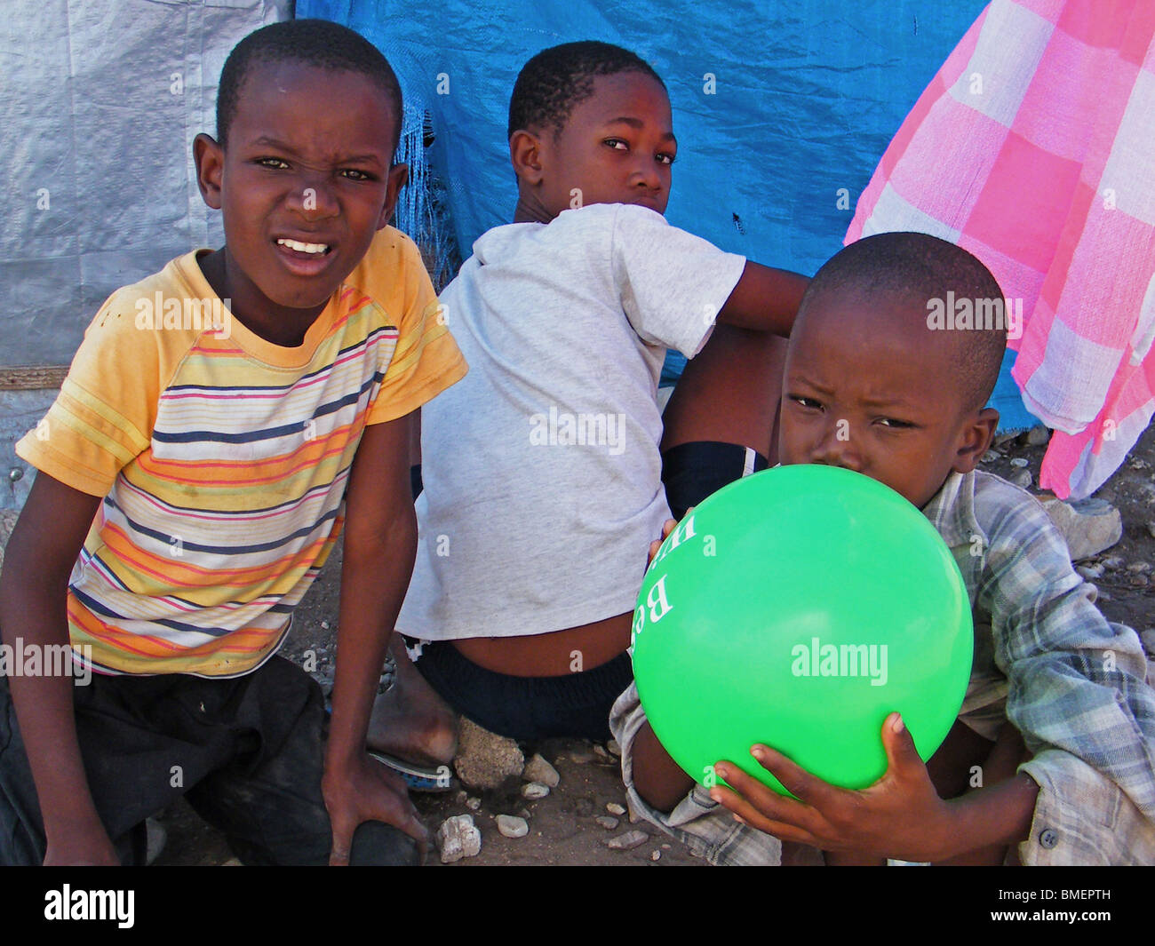 Children play with a balloon in a camp for people displaced by the 2008 hurricane season in Gonaives, haiti Stock Photo