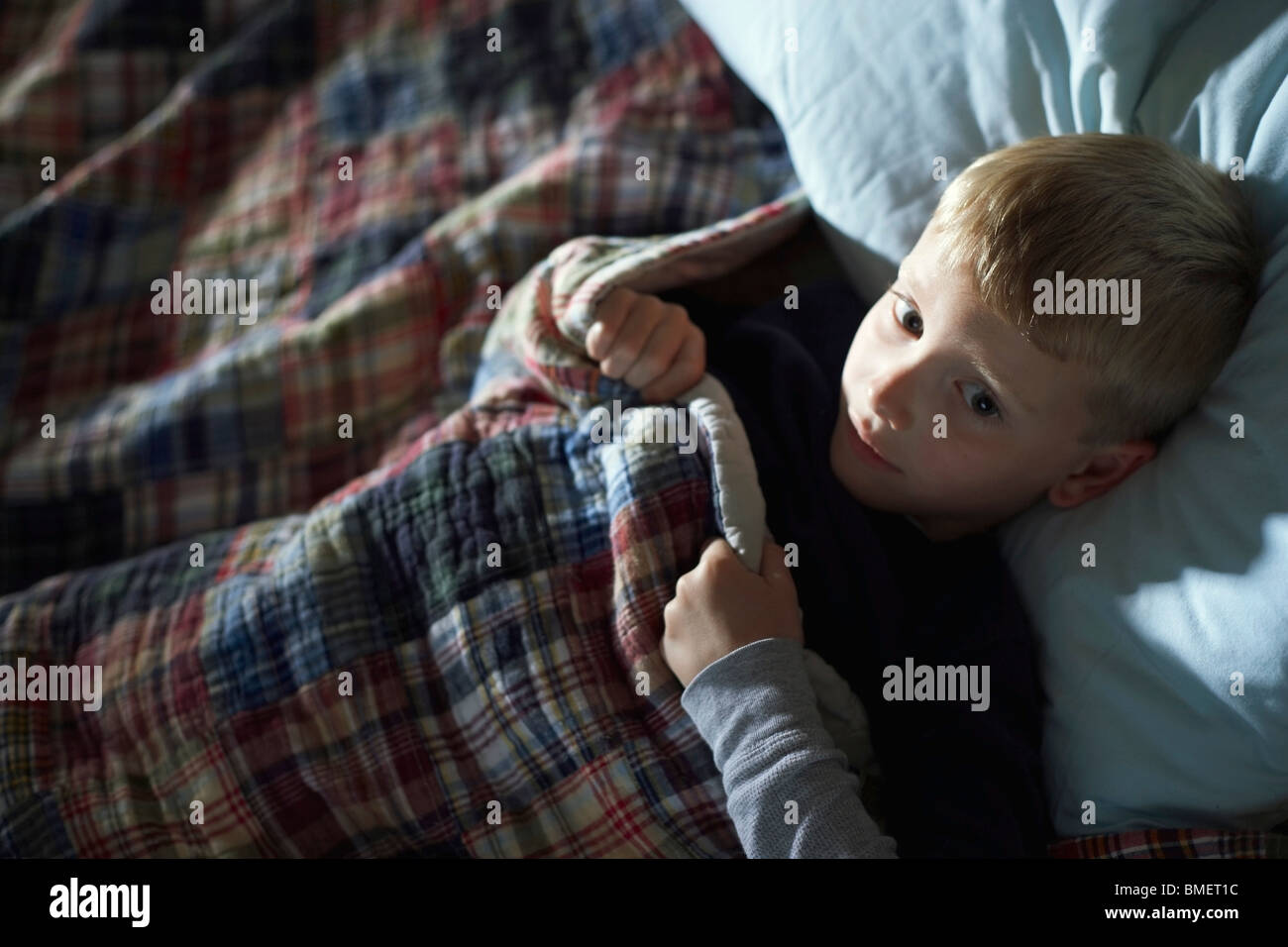 A Boy Laying Awake In Bed Stock Photo Alamy