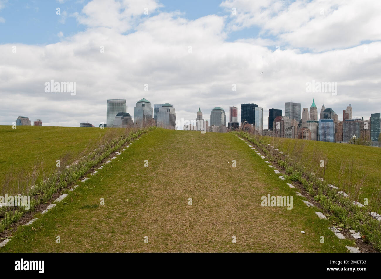 Two rows of flowerbeds mark the line sight of the missing Twin World Trade Towers on the New York City skyline as seen from NJ. Stock Photo