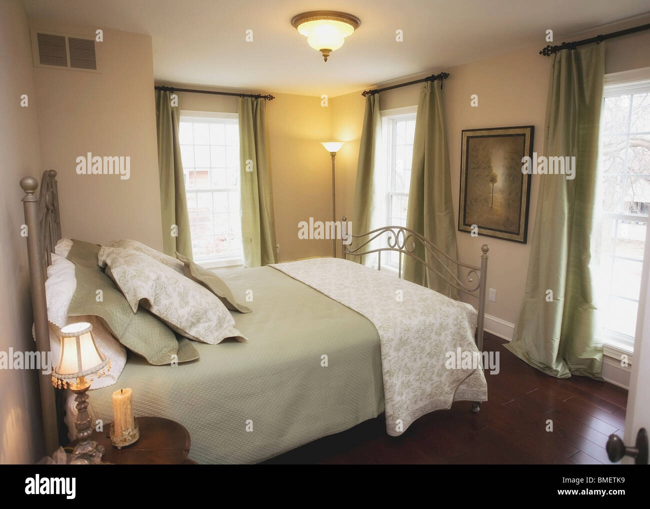 A Bedroom With Large Windows Stock Photo