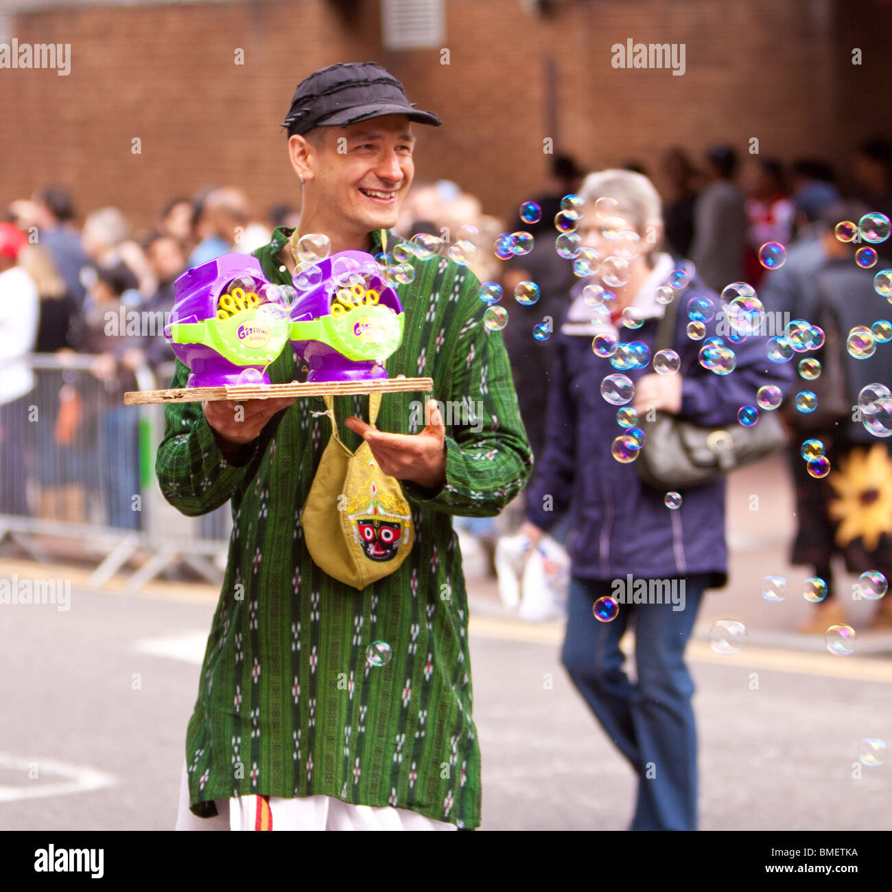 Hare Krishna man creating bubbles at the Luton International Carnival Stock Photo