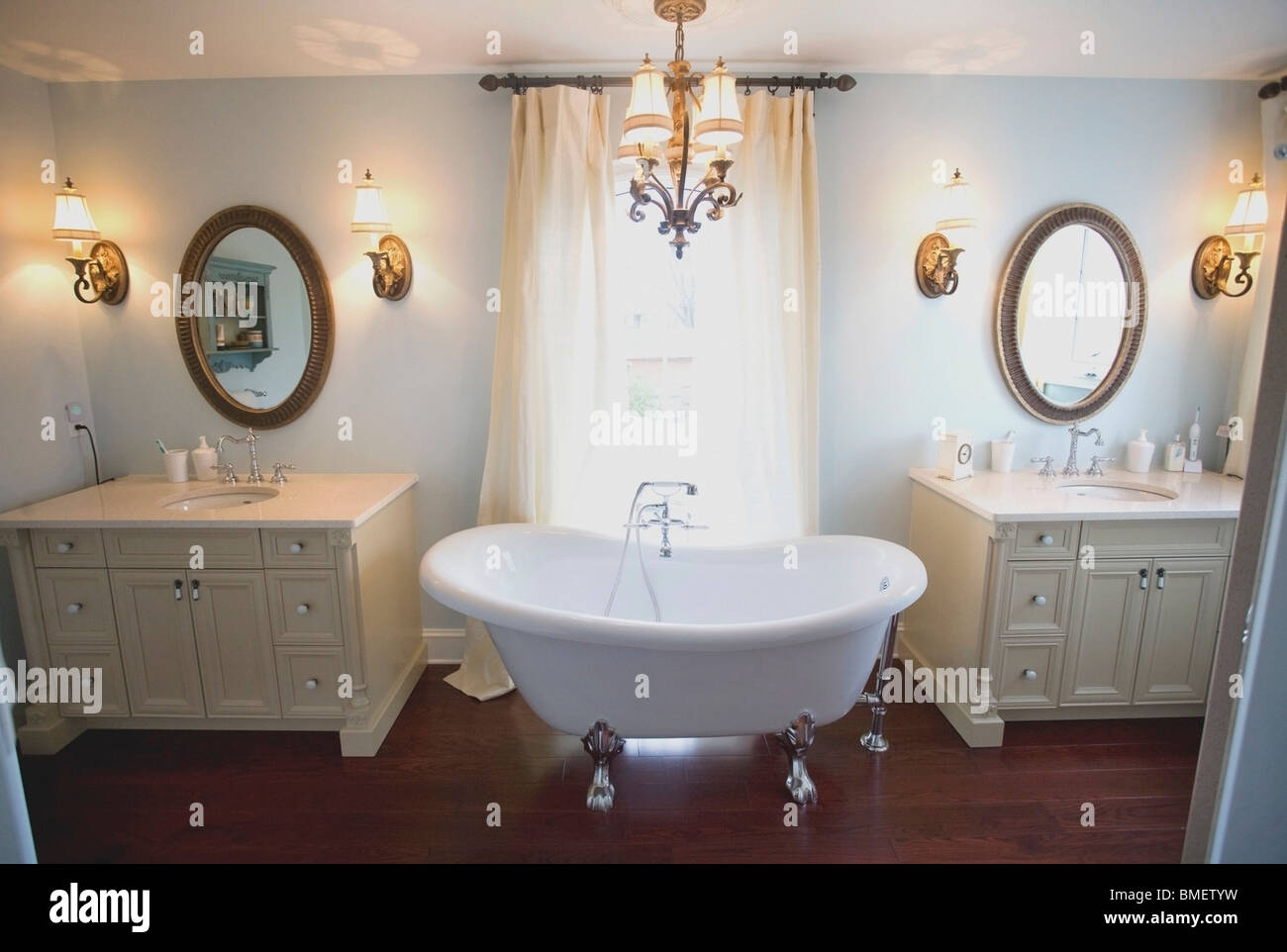 A Bathroom With Double Sinks And A Clawfoot Tub Stock Photo