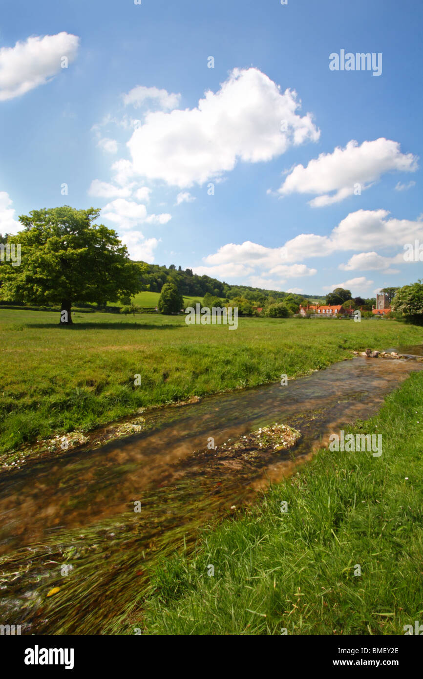 Hambleden Brook with Hambleden village in the background. Buckinghamshire, United Kingdom Stock Photo