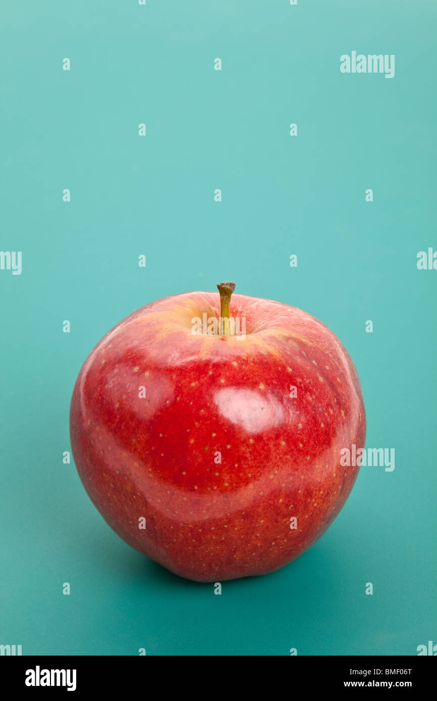 Red Apple with green background Stock Photo