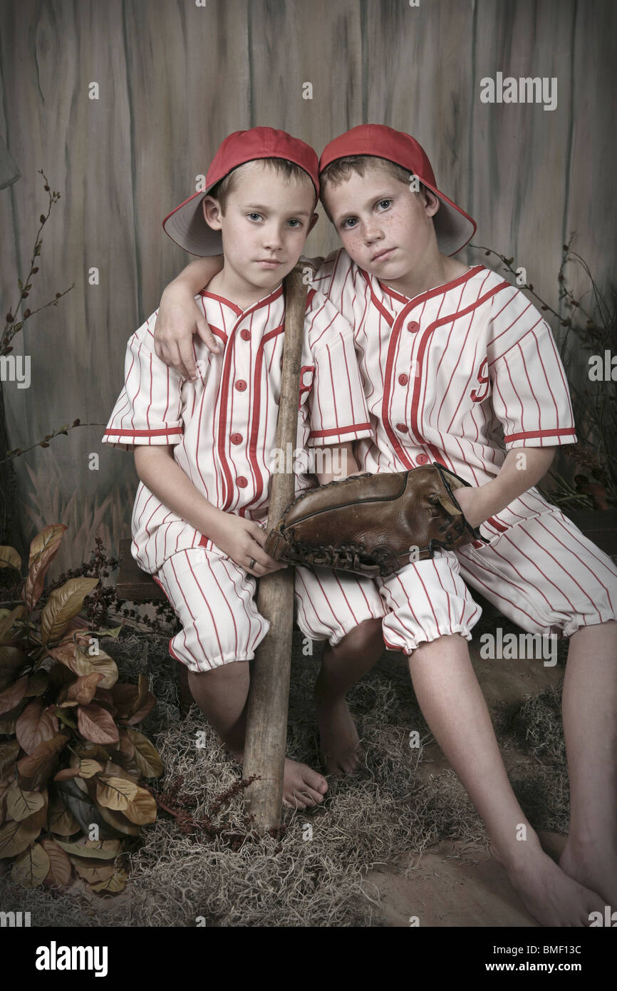 Two Boys Wearing Baseball Uniforms Stock Photo