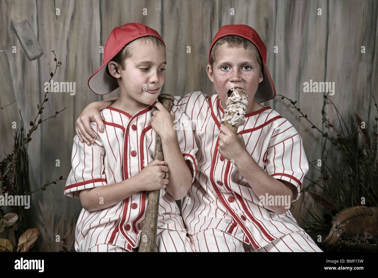 Two Boys Wearing Baseball Uniforms And One Is Eating An Ice Cream Cone  Stock Photo - Alamy