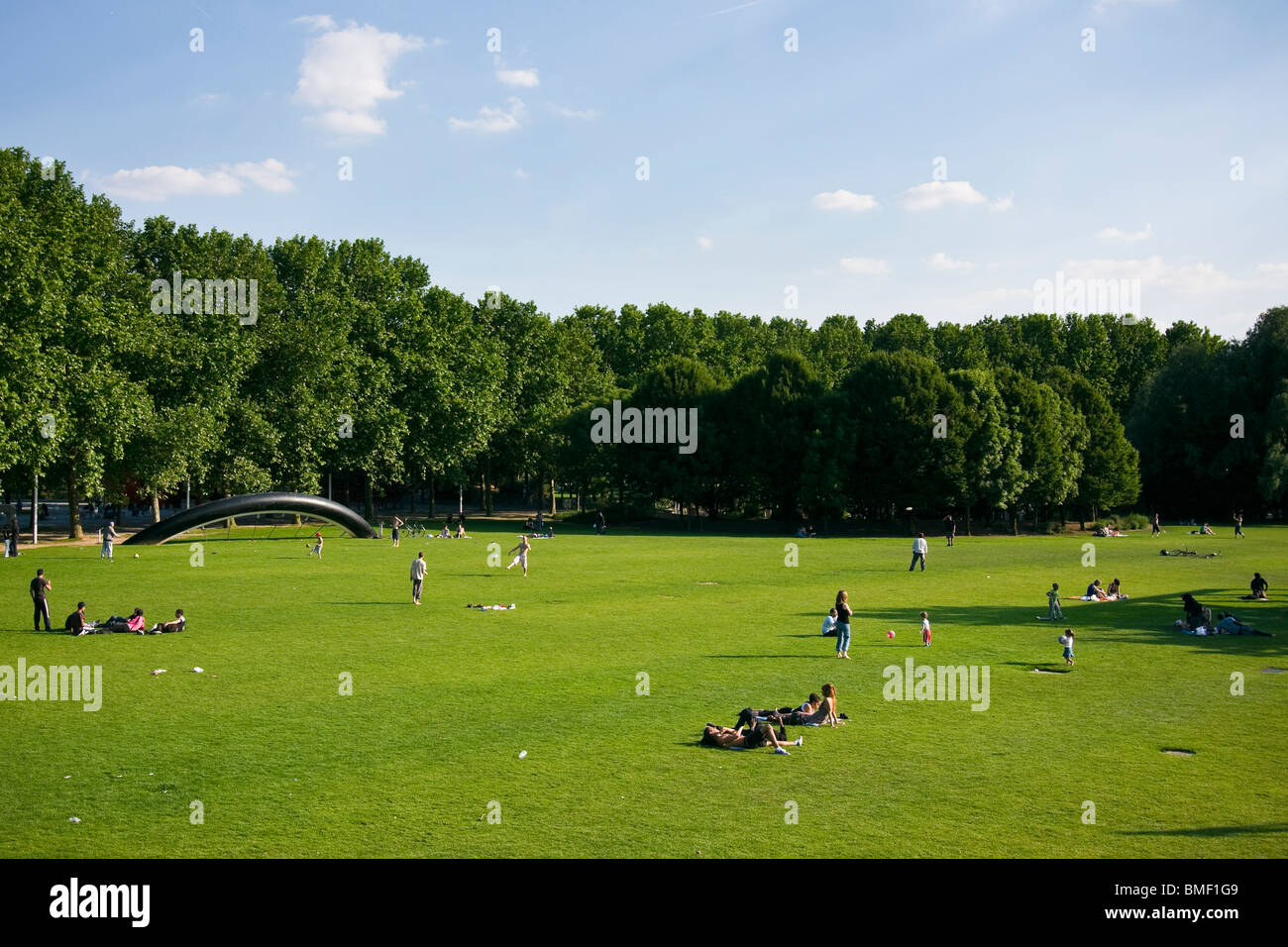 Parisians enjoy a sunny day in Parc de la Villette Stock Photo