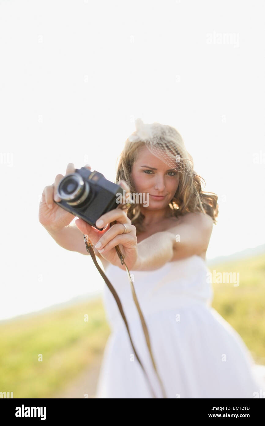 A Bride Holding A Camera Stock Photo