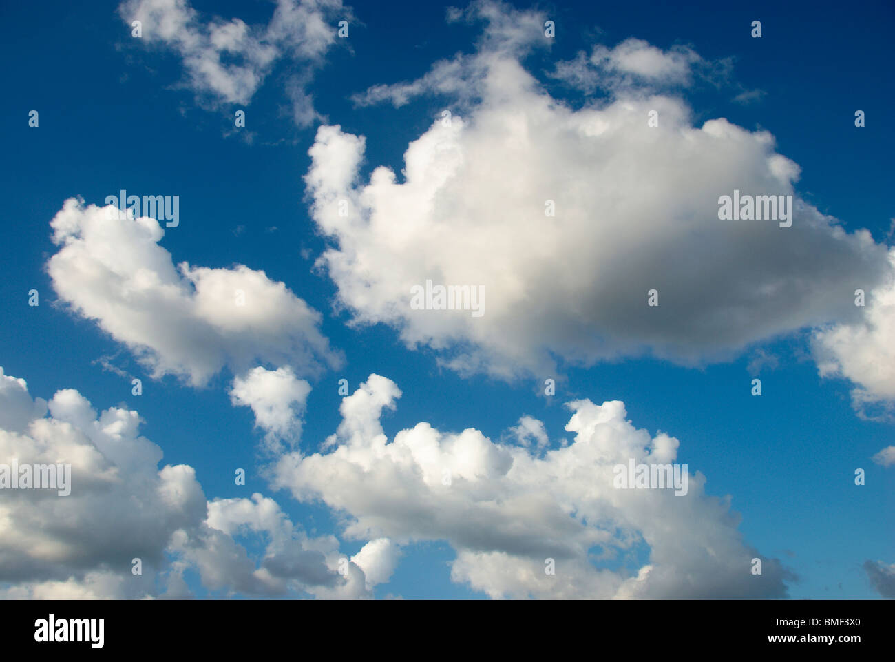 White fluffy clouds on a deep blue sky Stock Photo - Alamy