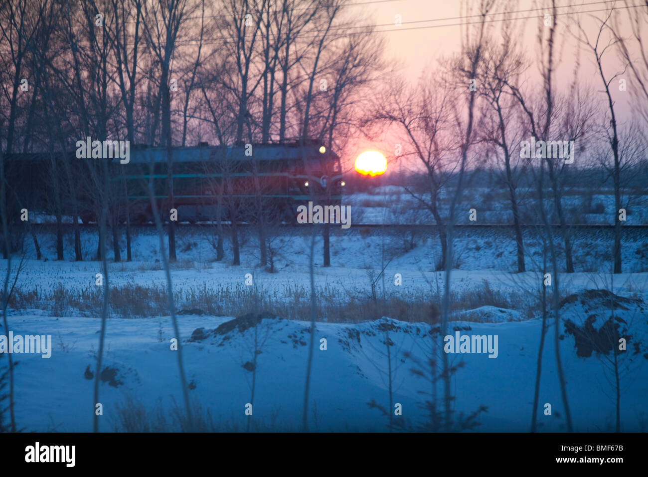 Train driving in sunset, Morin Dawa Daur Autonomous Banner, Hulunbuir, Inner Mongolia, China Stock Photo