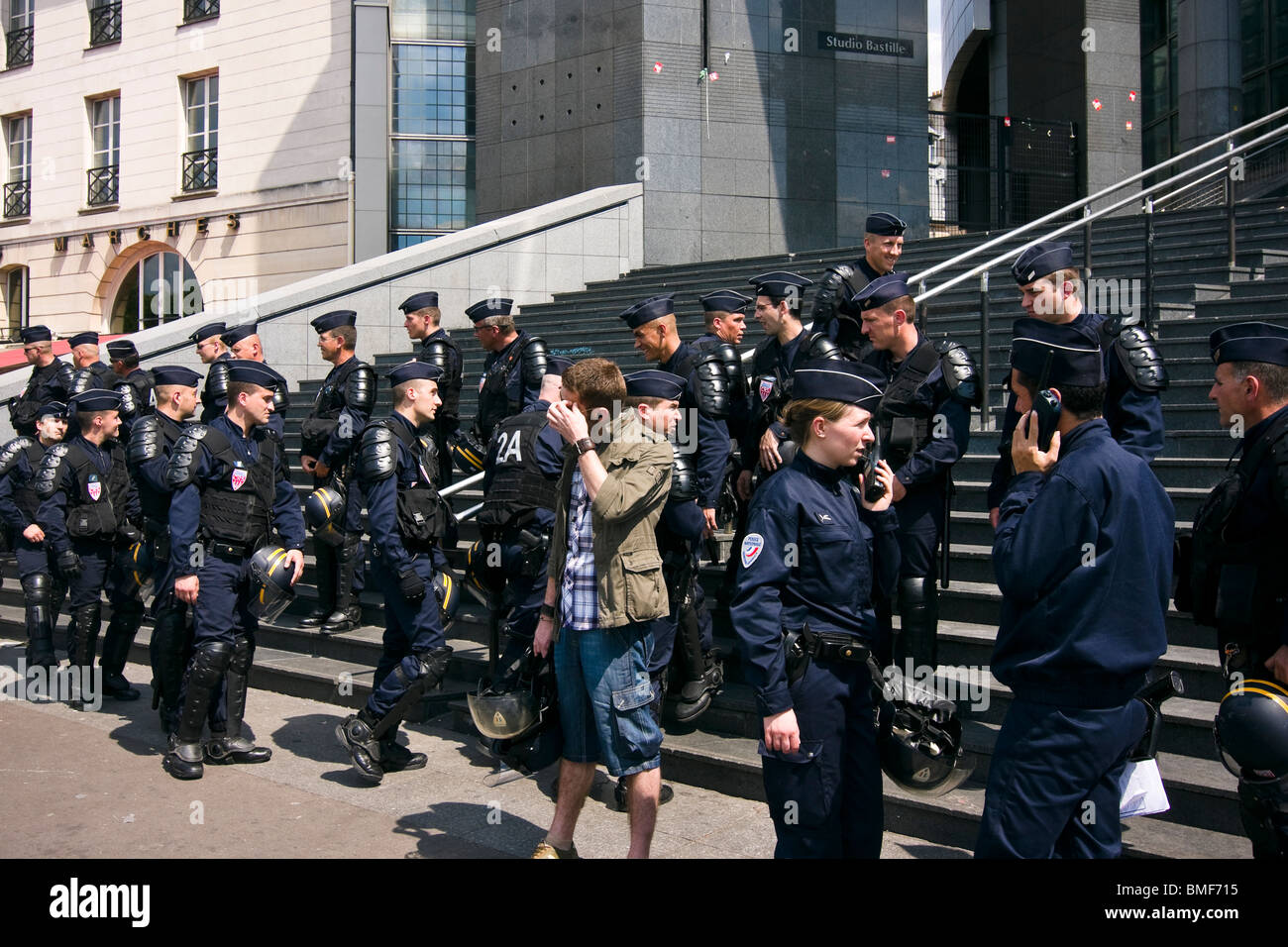 Anti-riot policemen protect the Opera Bastille during the undocumented workers demonstration in Paris Stock Photo