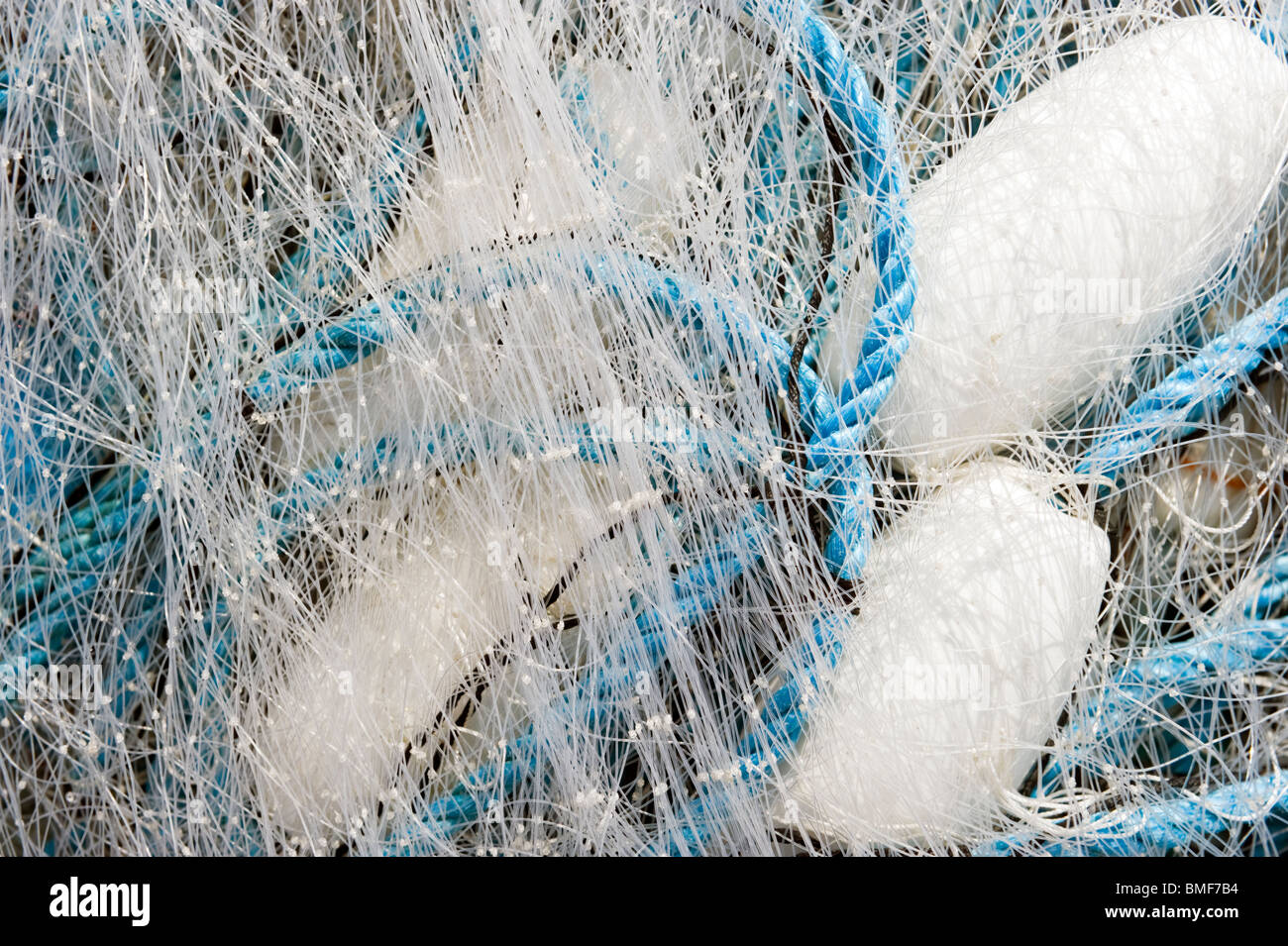 A pile of ropes nylon monofilament fishing nets and marker buoys