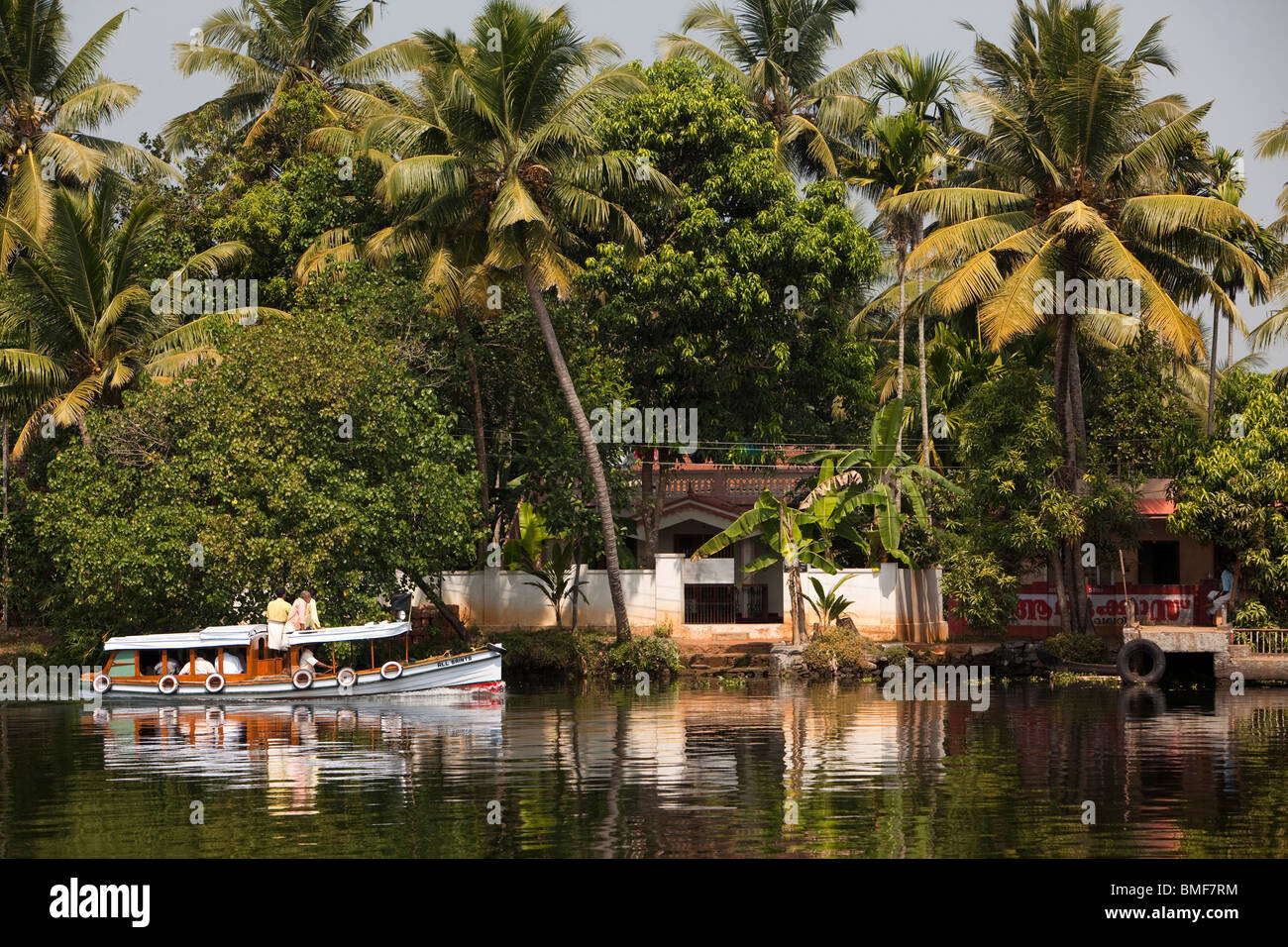 India, Kerala, Alappuzha, Chennamkary, backwaters, small local boat taking mourners to funeral Stock Photo