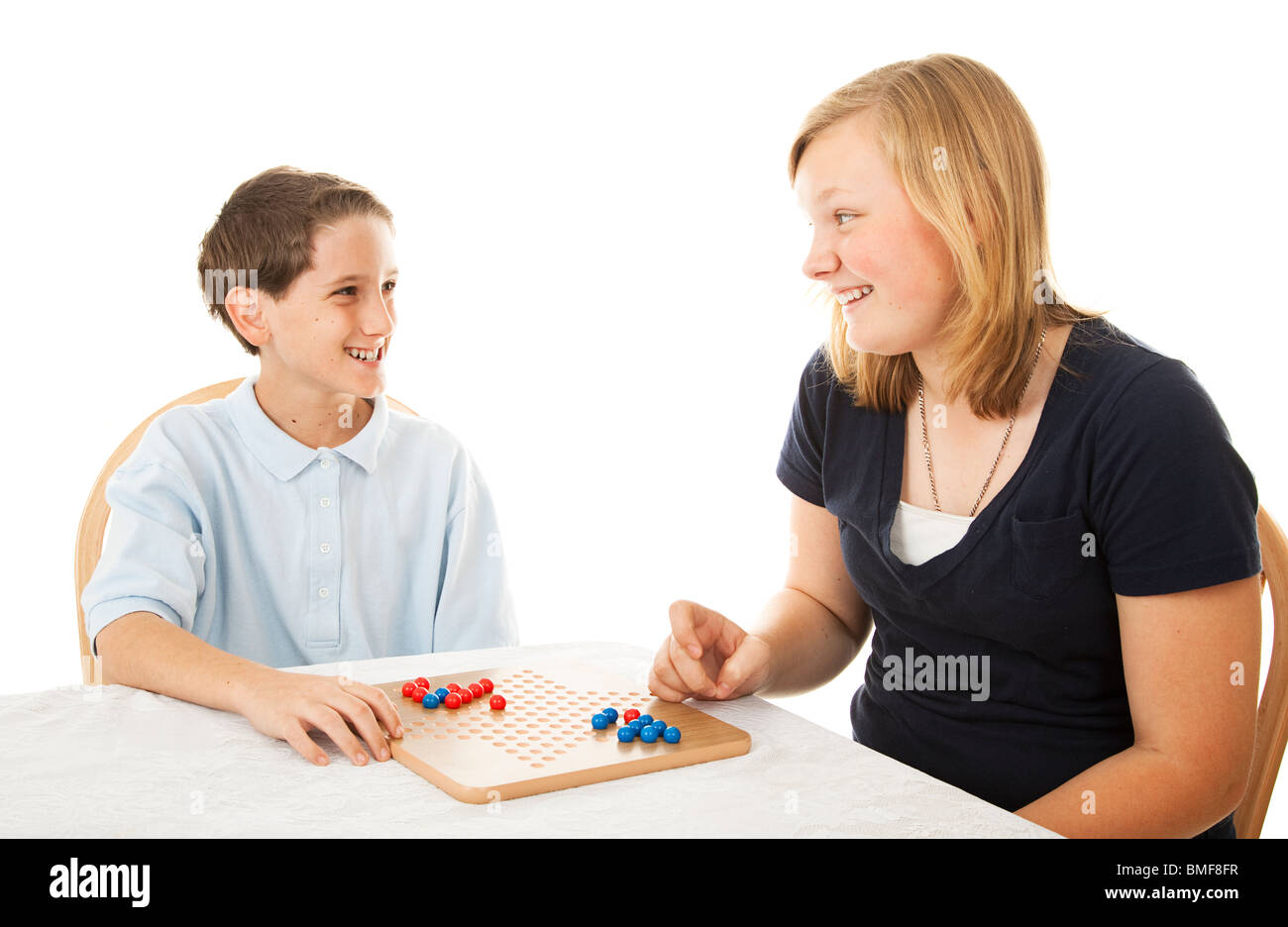 Brother and sister play a board game together. Isolated on white Stock  Photo - Alamy