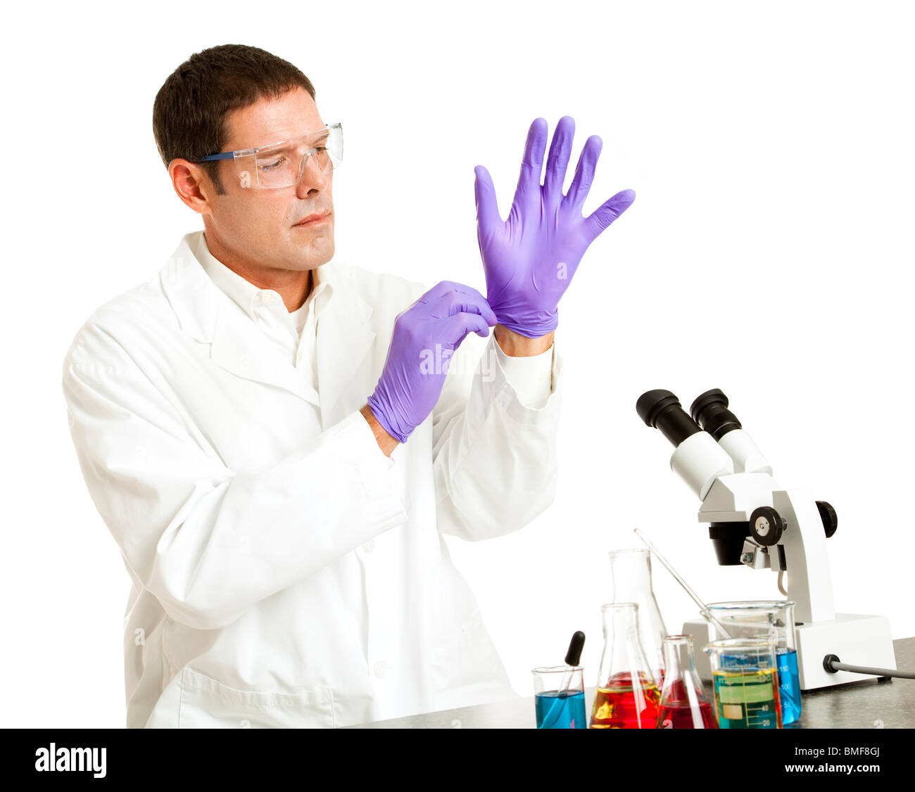 Scientist putting on rubber gloves to protect from chemicals. Isolated