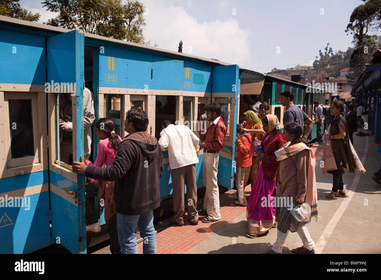 India, Tamil Nadu, Coonor Station Nilgiri Mountain Railway, Indian tourists boarding train Stock Photo