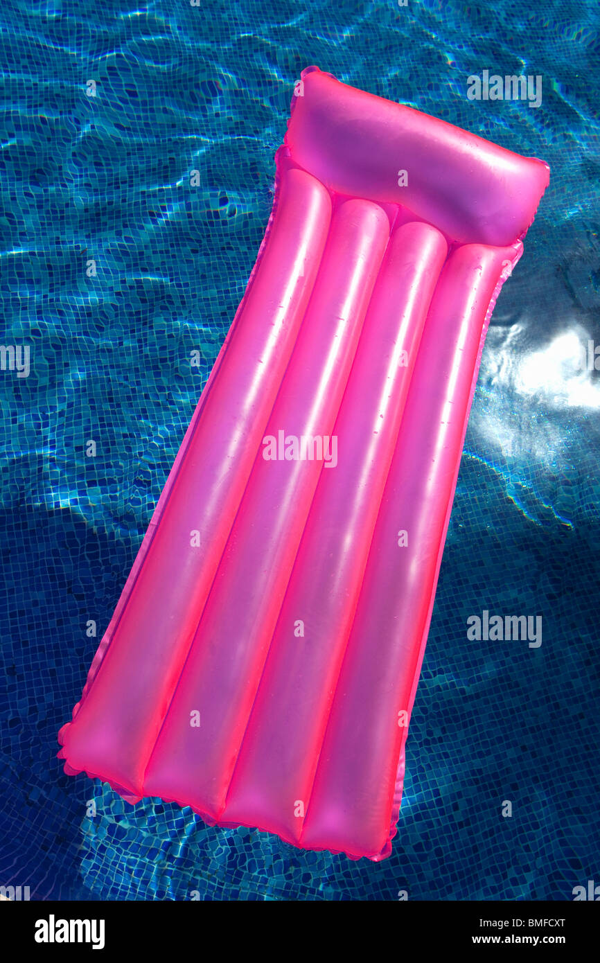 Pink, lilo, airbed, in, swimming, pool, in, sunshine, summer Stock