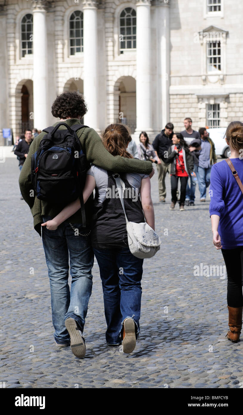 Trinity College Dublin Ireland students walking with arms around each