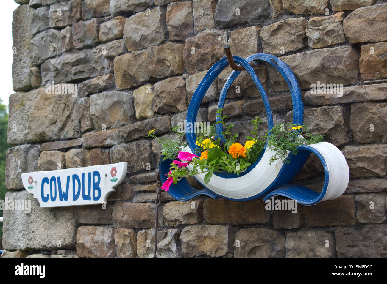 Old Tyre Planter with Flowers, Yorkshire, England Stock Photo