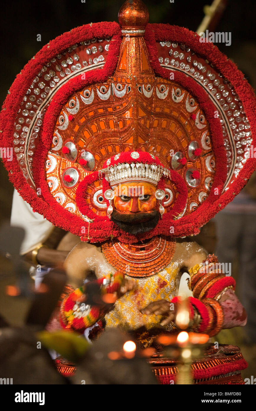 India, Kerala, Cannanore (Kannur), Theyyam, ancient pre Hindu folk art ritual, costumed figure at altar Stock Photo