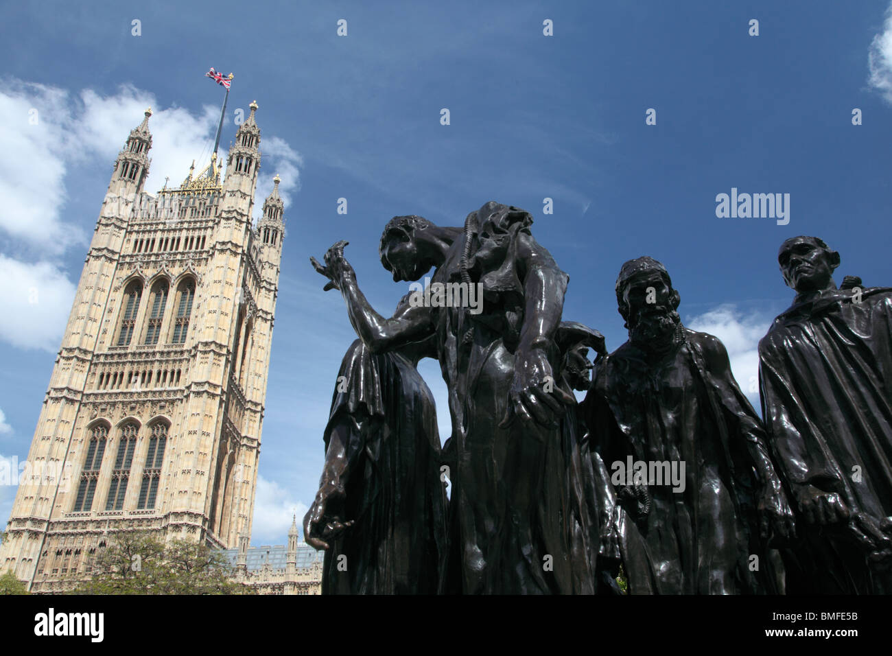 The Burghers of Calais sculpture in Victoria Tower Gardens with the Palace of Westminster in the background, London, SW1. Stock Photo