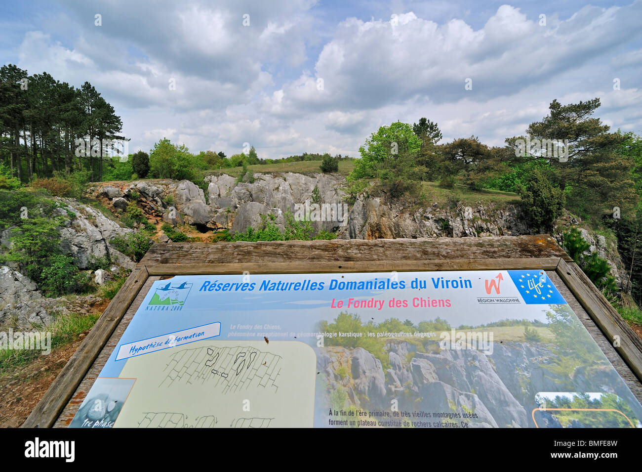 Information panel about the eroded rocks of ravine in the nature reserve Fondry des Chiens, a sinkhole near Nismes at Viroinval Stock Photo