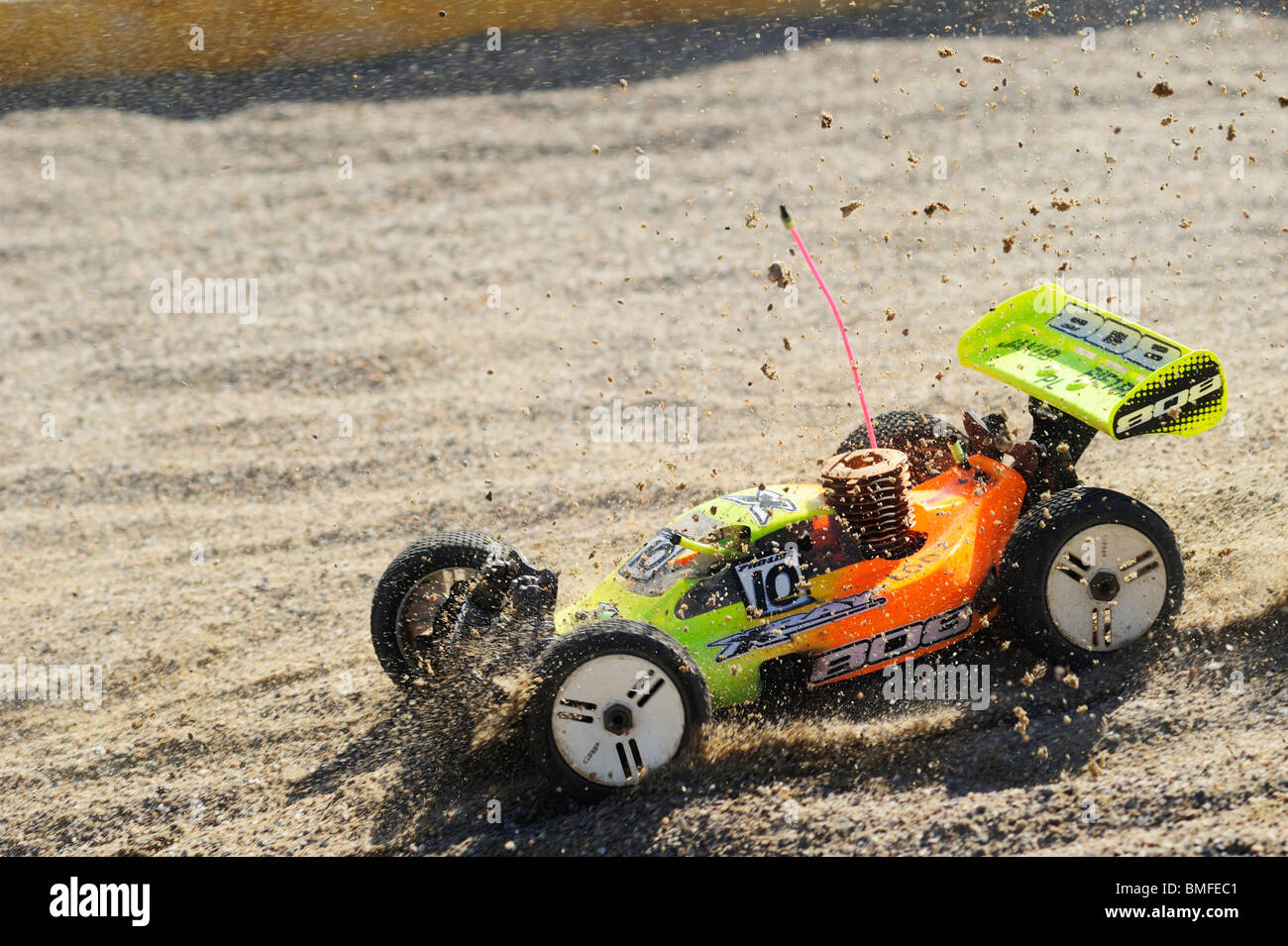 A radiocontrolled model racing car caught at the moment of landing at