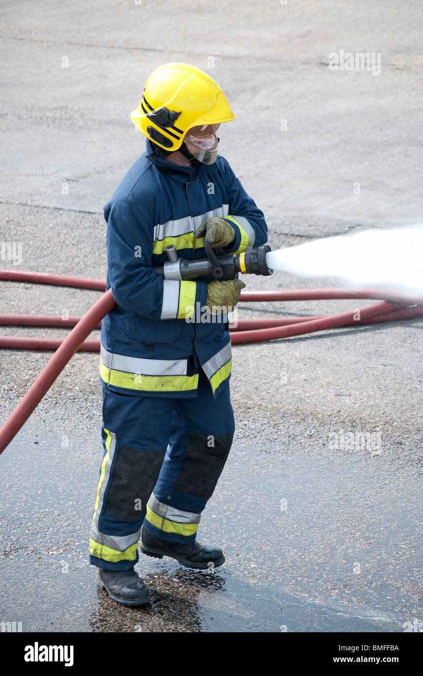 Firemen using hose hi-res stock photography and images - Alamy