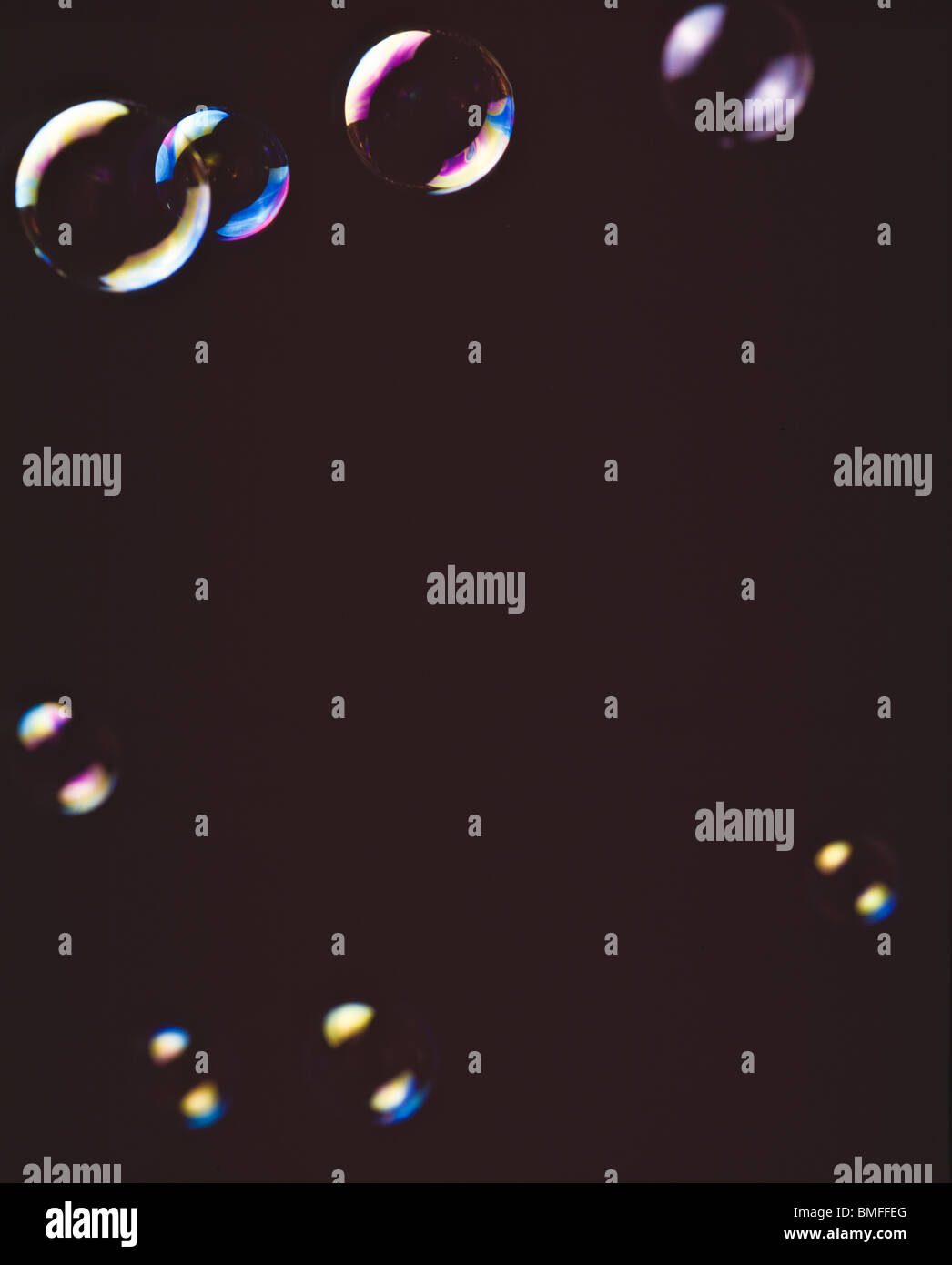 Assorted soap bubbles floating against black background Stock Photo - Alamy