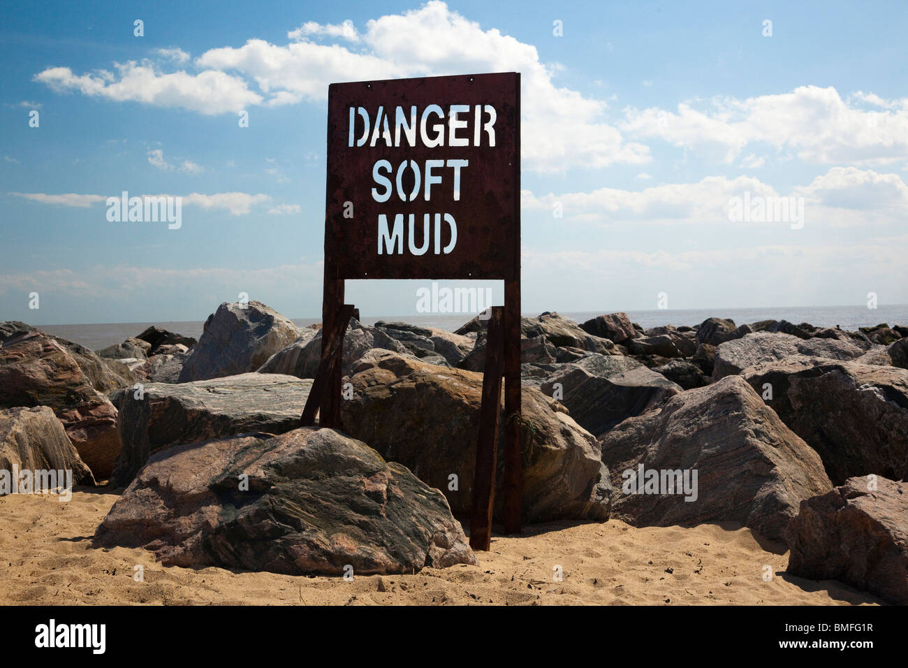 danger sign warning of soft mud at beach in UK Stock Photo