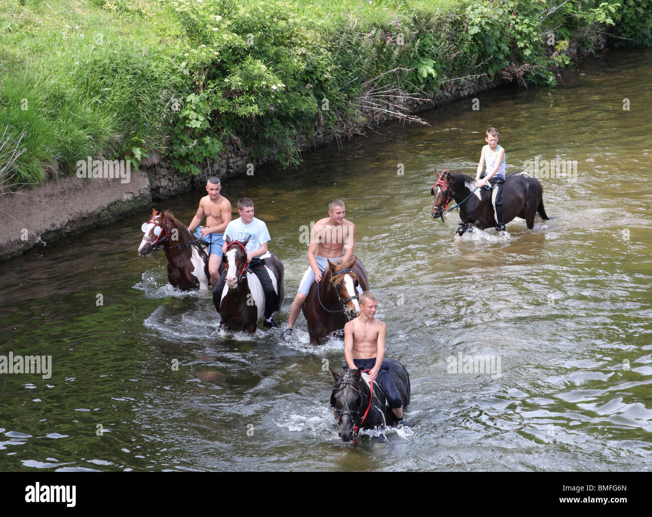 Gypsy boys swimming horses at the Appleby Horse Fair, ApplebyIn