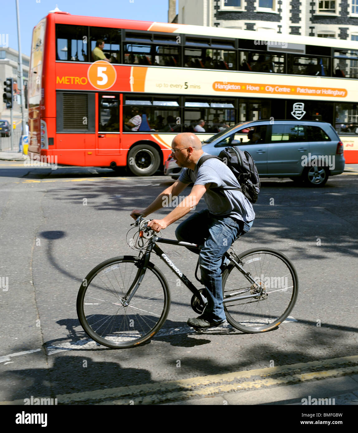 Cyclist in amongst busy traffic in Brighton city centre UK 2010 Stock Photo
