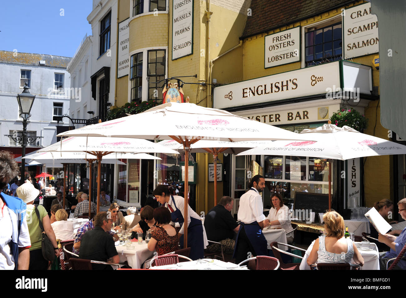 Staff serving customers outside the famous English's Oyster Bar and Seafood restaurant Brighton UK Stock Photo