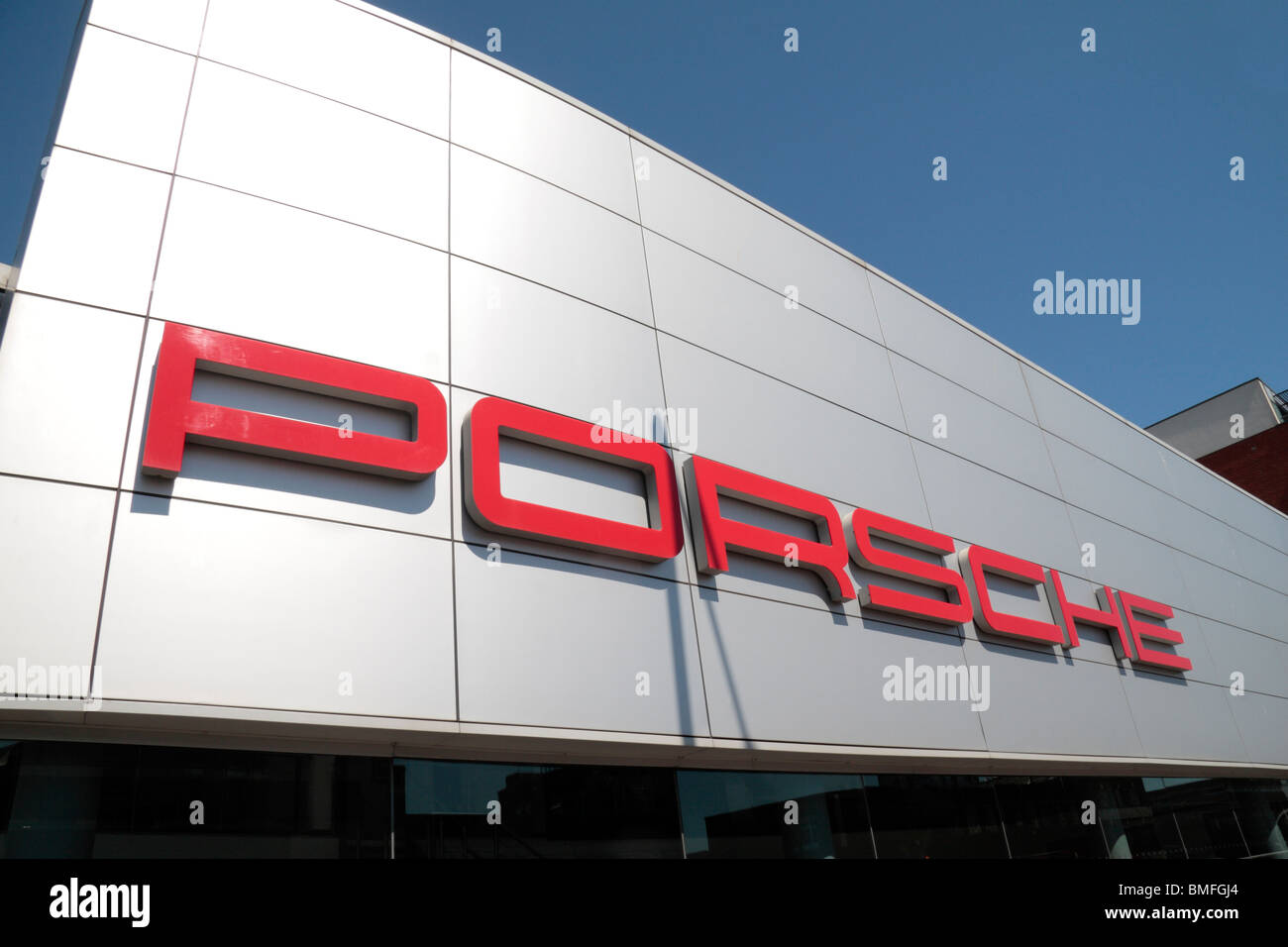 The Porsche logo on the shop front of the Stratford, East London branch. Stock Photo