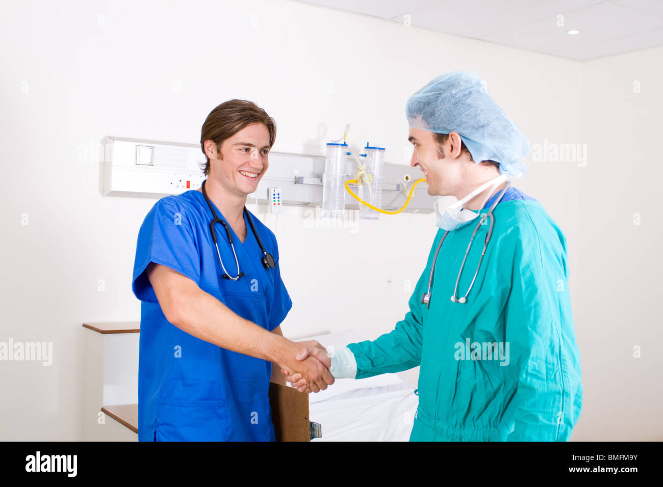 two male doctor handshake in hospital ward Stock Photo