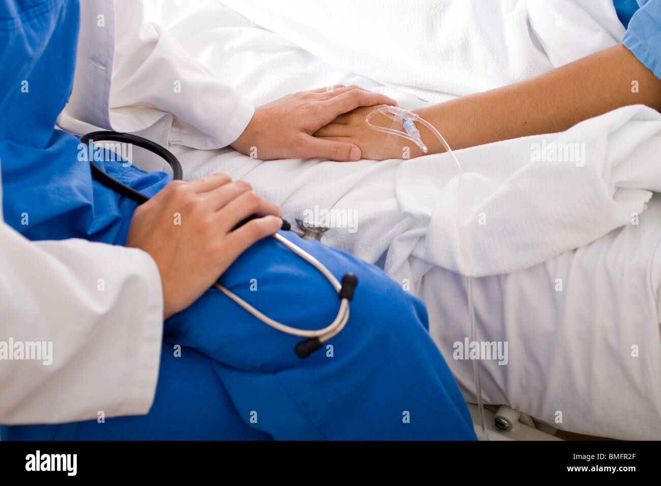 caring doctor comforting hospitalized patient Stock Photo