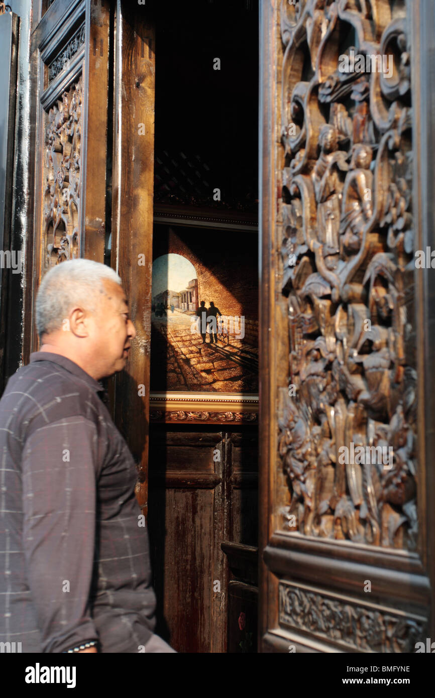 Elderly Man Walking Into A With Exquisitely Carved