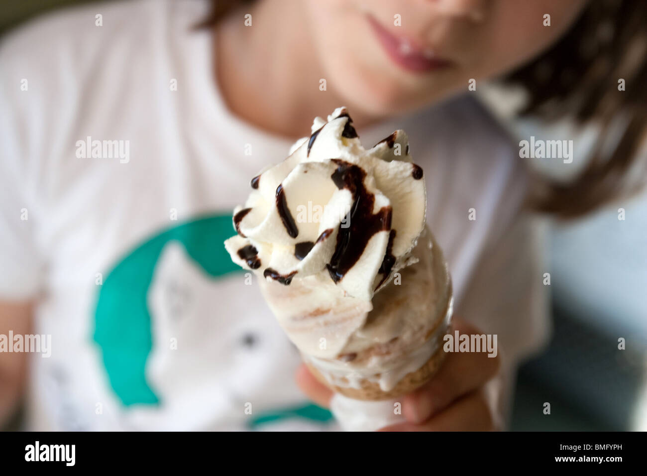 Girl eating 'ice cream' gelato cone outdoor in Italy. Stock Photo