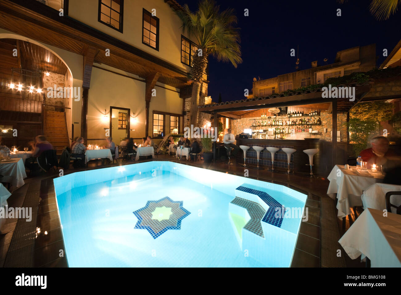 Turkey Antalya - the Hotel Alp Pasha, Ottoman boutique hotel in old city - restaurant area with swimming pool at night Stock Photo