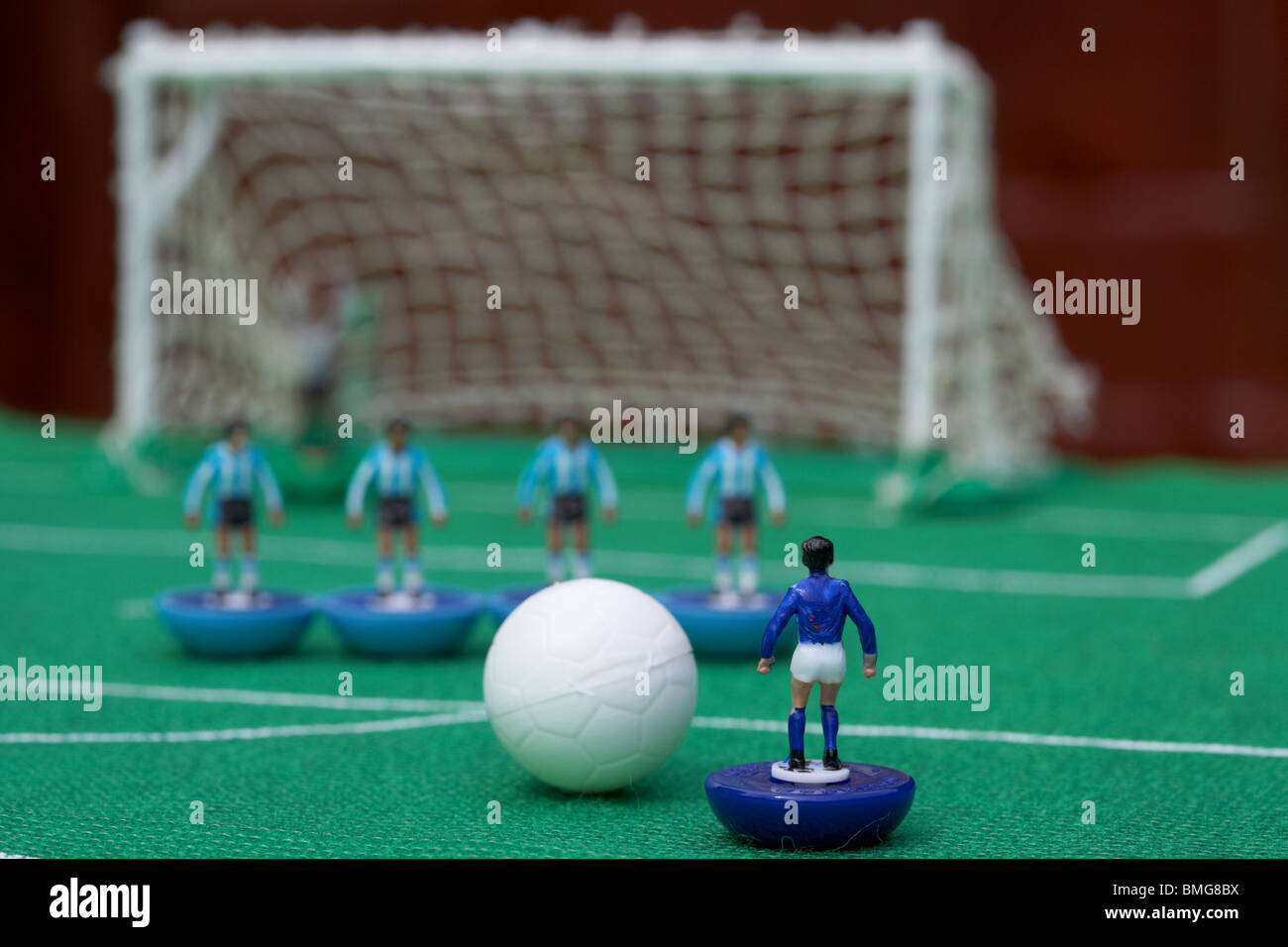 free kick with wall of players football soccer scene reinacted with subbuteo table top football players game Stock Photo