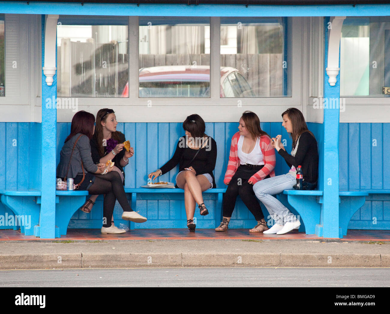 group of young teenage girls in a bus shelter Stock Photo