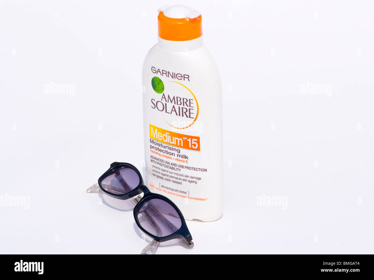 A Bottle Of Suncream and A Pair Of Sunglasses Isolated On A White Background Stock Photo