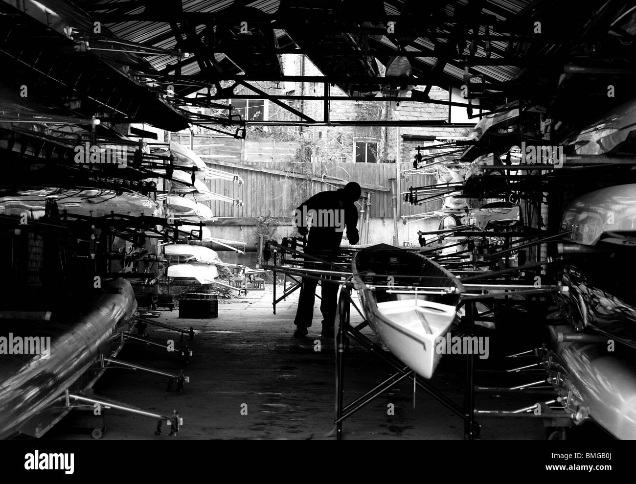 Rowing and sculling boats pictured in the Vesta Rowing Club boat shed at the Mens Head of The River Race in London. Stock Photo