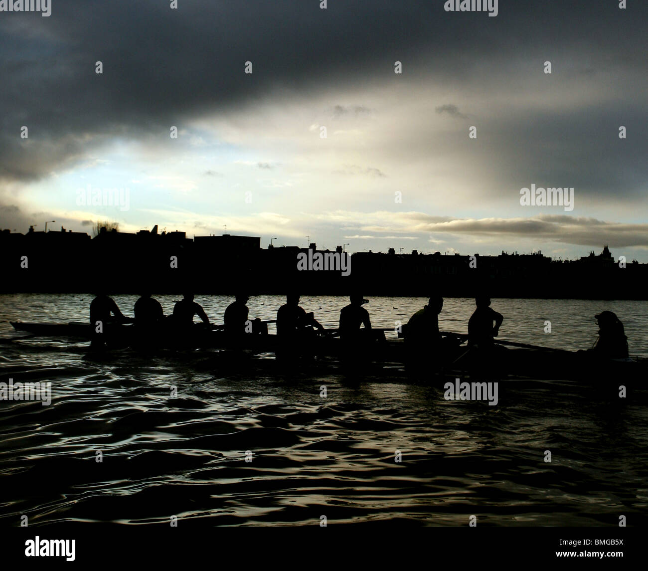 A novice eight crew from Vesta Rowing Club practice on the river Thames near Chiswick in London. Stock Photo