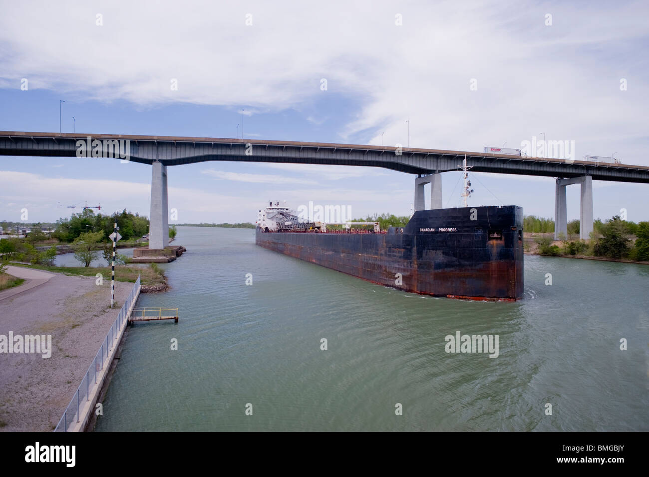 'Laker' style freighter passes under bridge on the Welland Canal, St. Catherines, Ontario, Canada. Stock Photo