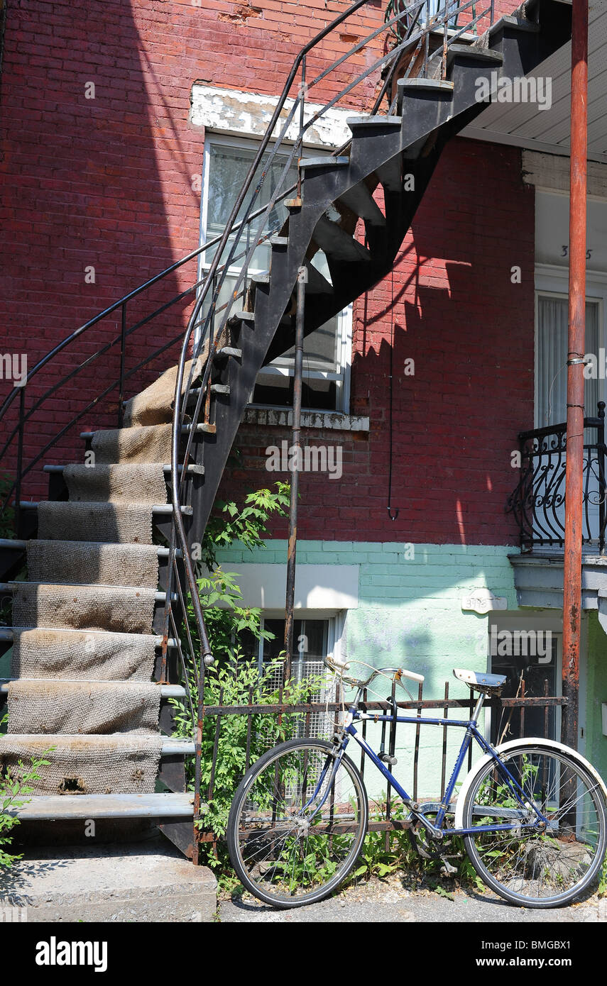 Spiral staircase and bicycle in Latin Quarter Montreal. Stock Photo