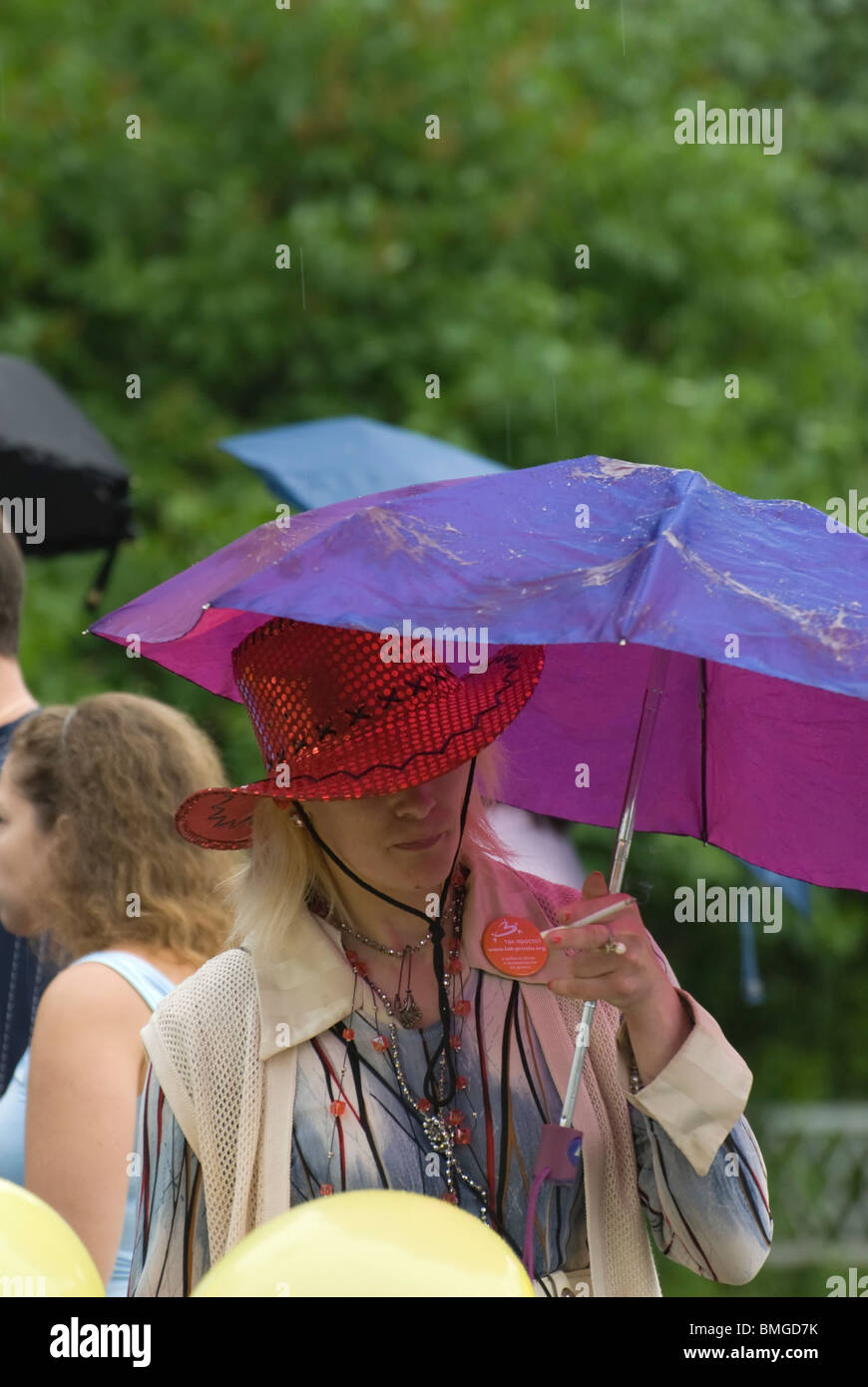 Lady with cigarette under umbrella Stock Photo Alamy