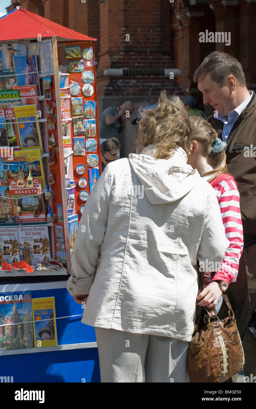 Tourist family choosing a travel map and souvenirs near the Moscow Red Square Stock Photo